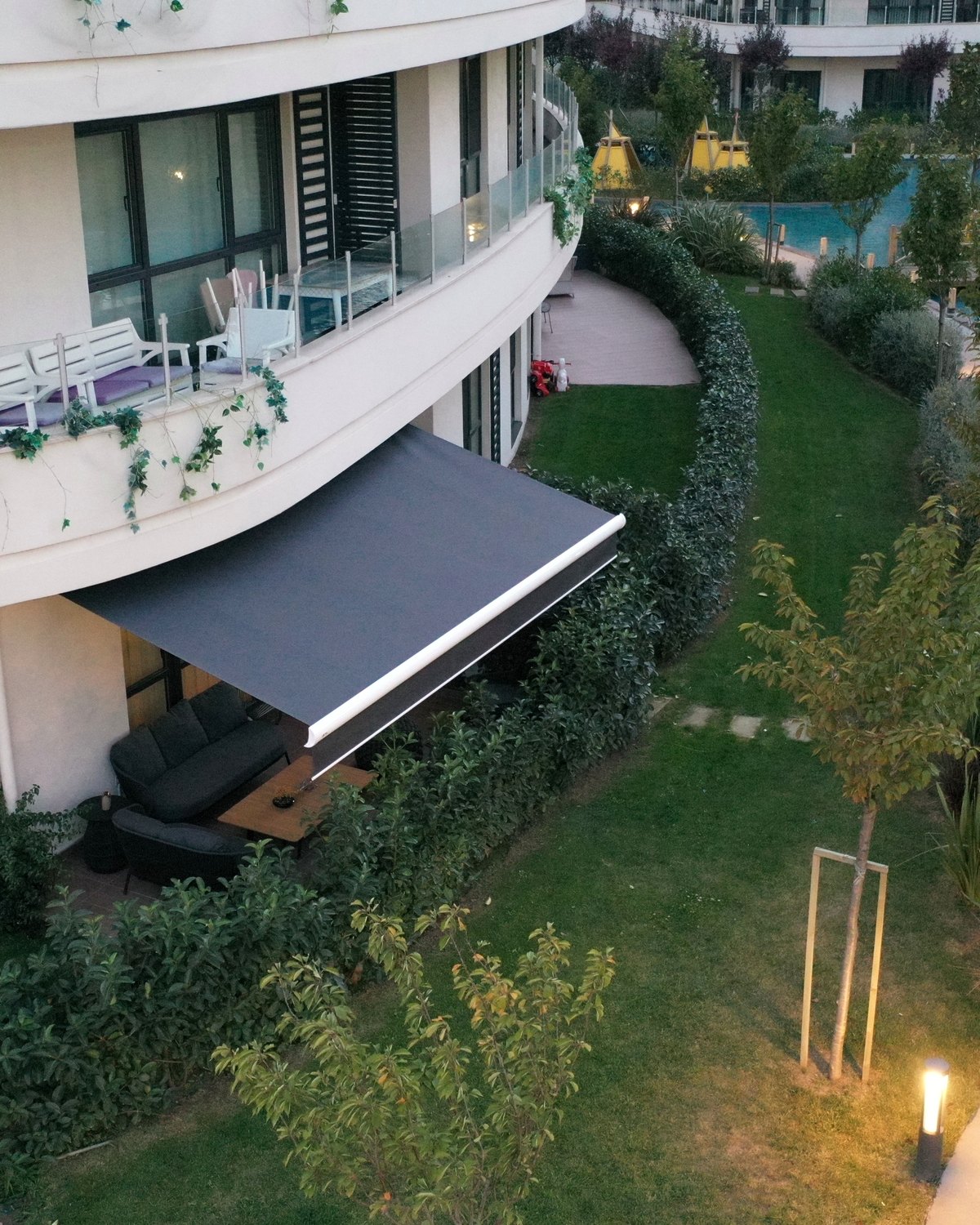 Rising motorised folding arm awning on a residential facade