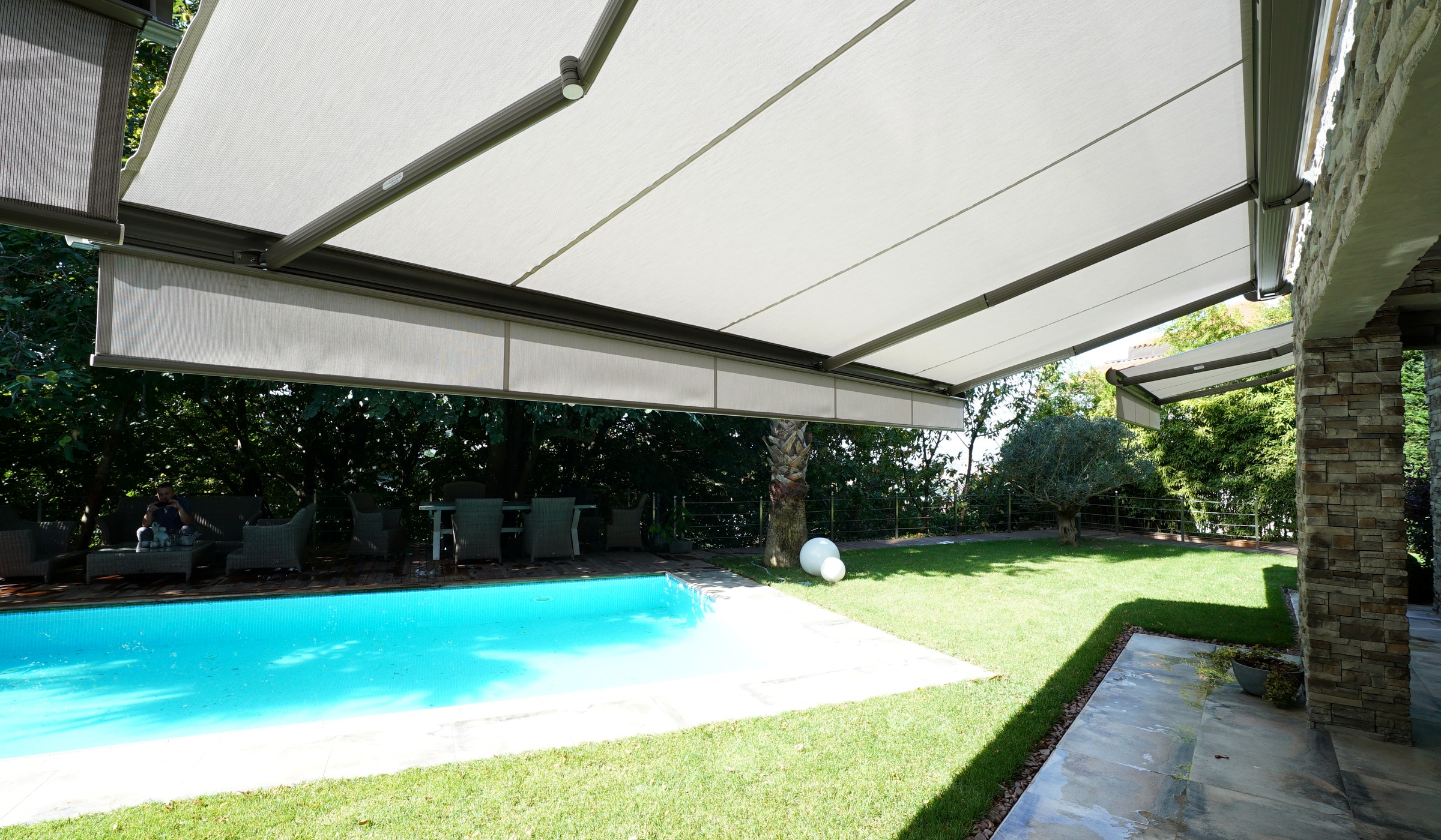 Full cassette awning over a poolside terrace