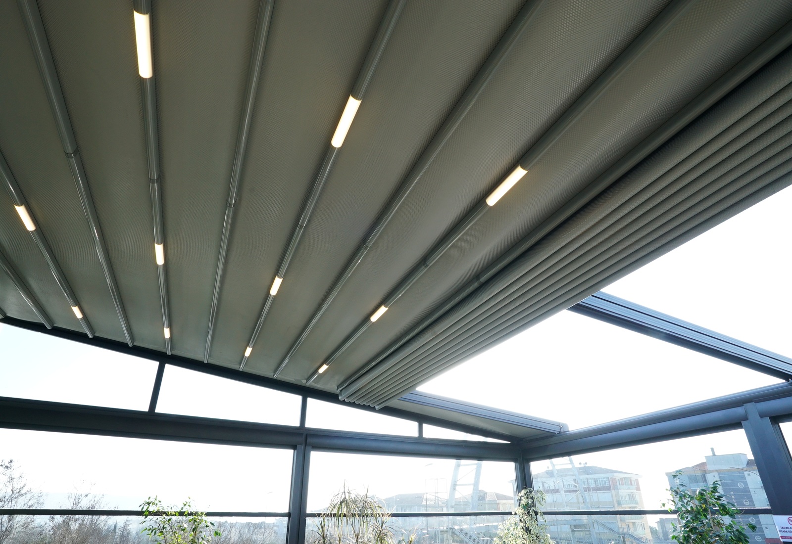 Retractable fabric roof with integrated LED lighting seen from below